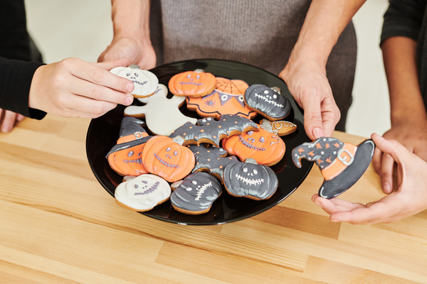Someone Holds Plate with Various Halloween Cookies